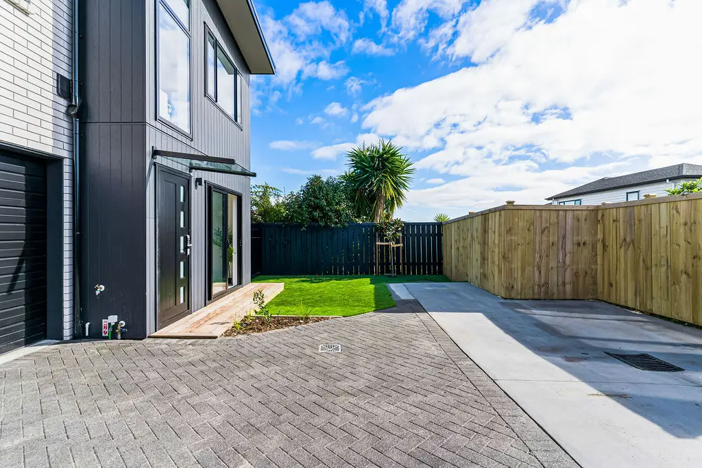 Stunning front-yard landscaping at a Bradbury Road property, featuring a manicured lawn, garden beds and pathway, designed by VOS