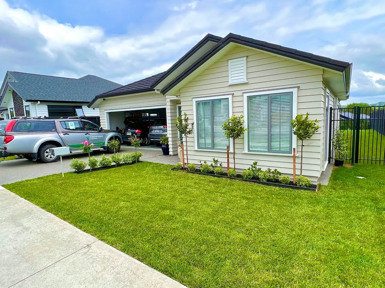 Landscape design by Visionary Outdoor Solutions – garden with lush greenery and stone pathways.