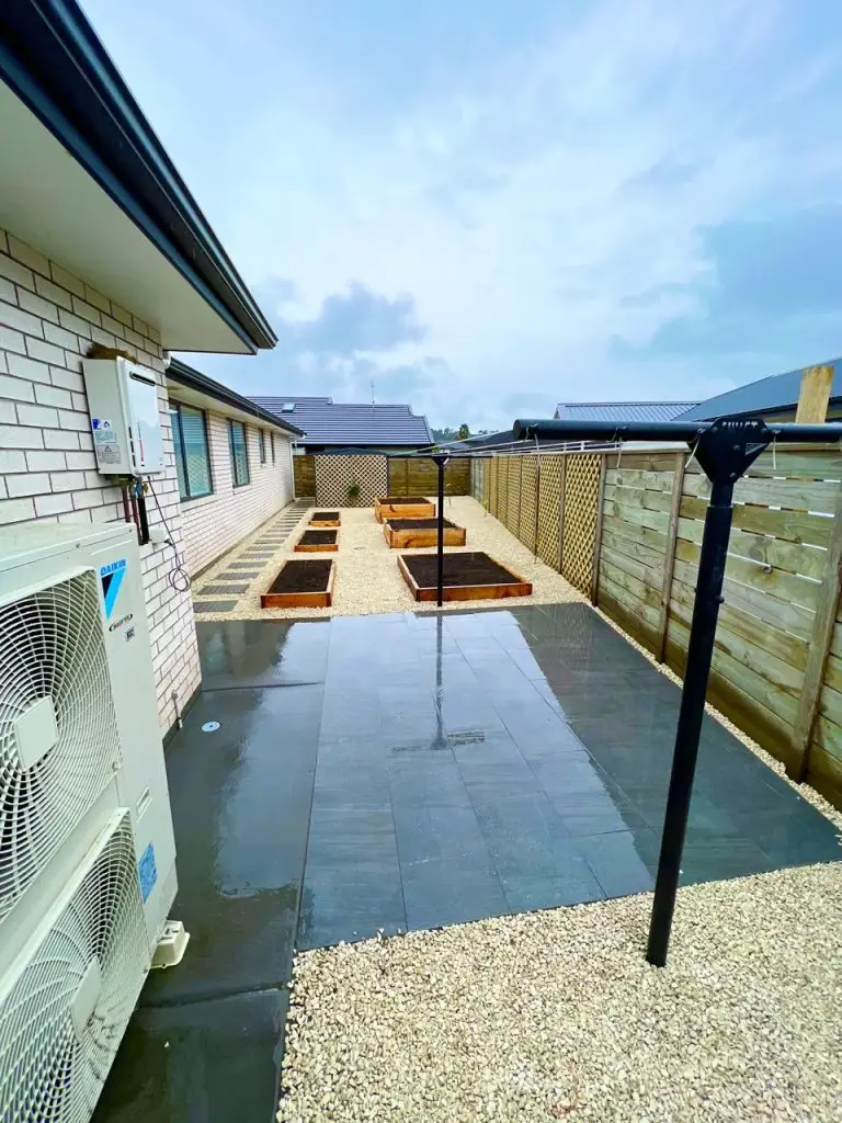 Landscaped garden with stone pathway by Visionary Outdoor Solutions