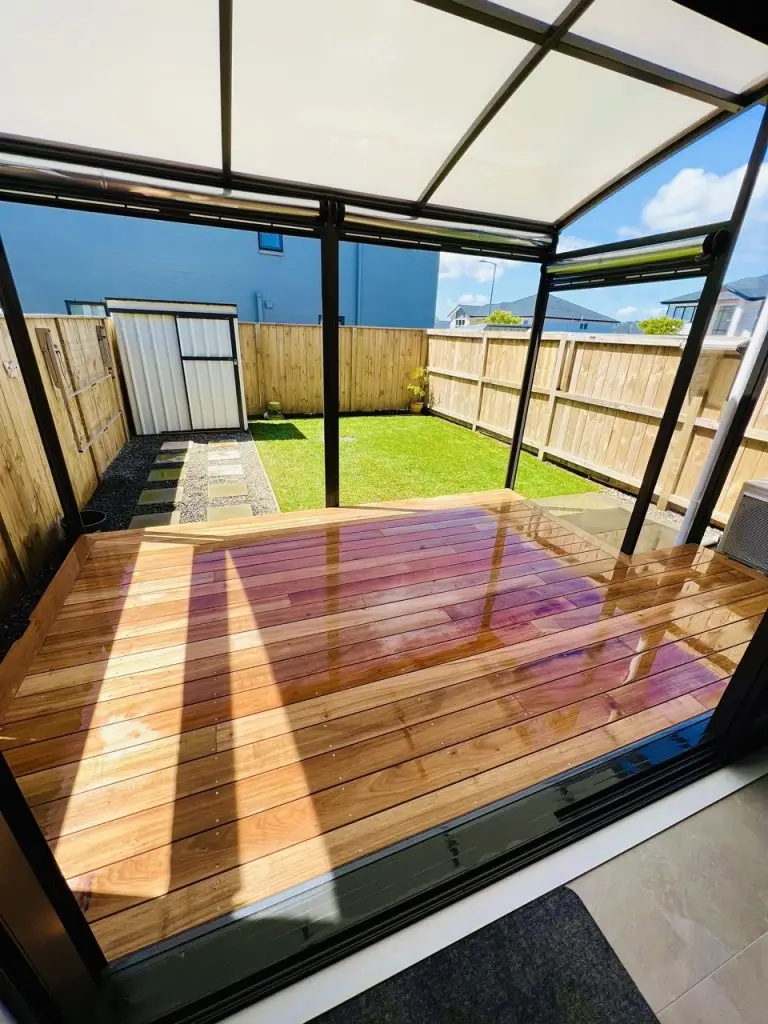 Modern living room interior designed by Visionary Outdoor Solutions featuring natural lighting, wooden flooring and neutral décor